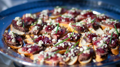 Catering image of crostinis with cheese and other toppings